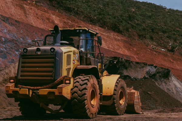 pexels-photo-31543889-31543889 Large yellow bulldozer at a construction site against a rocky hill backdrop.